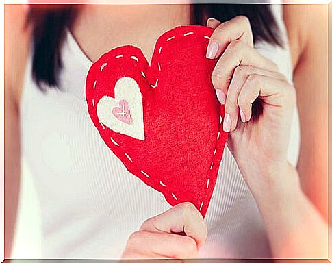 Woman holding a fabric heart