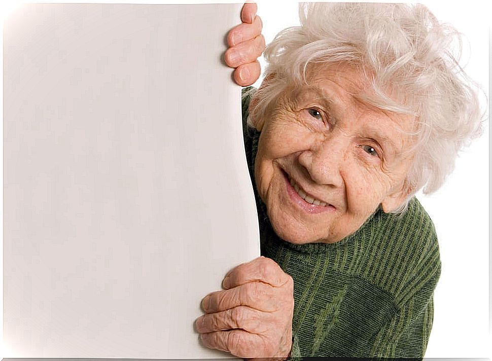 An elderly woman smiles.