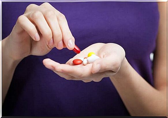 Woman with pills in hand