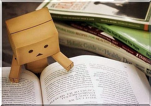 A cardboard figure reading a book