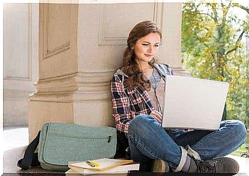 A girl sitting with a laptop