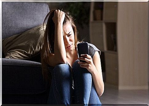 Girl with FOMO syndrome staring at smartphone.