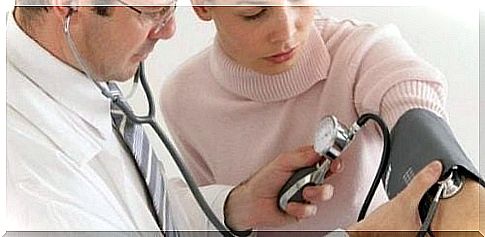 woman measures blood pressure at the doctor