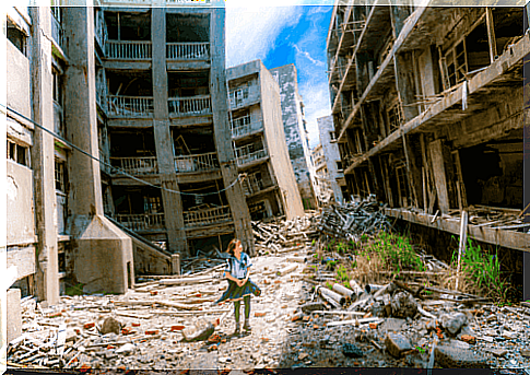 Girl goes to school in ruined city