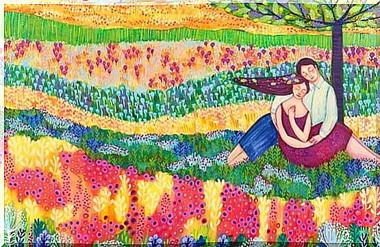 A happy couple in a colorful flower meadow