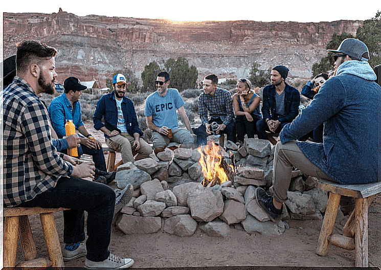 Friends are sitting around a campfire