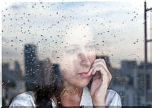 Woman looks like rainy window