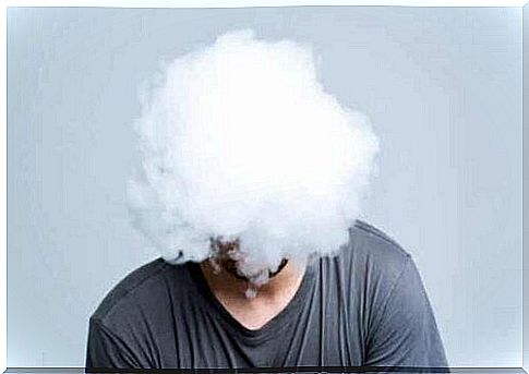 A man's head covered by a cloud.