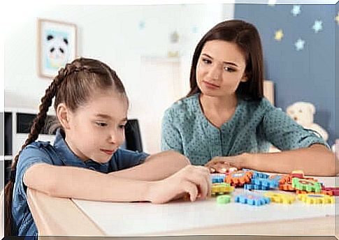 A teacher watching a girl play.