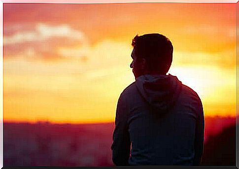 A man watching the sunset alone.