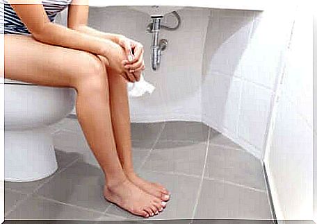 A woman on the toilet who experienced the key in door syndrome.