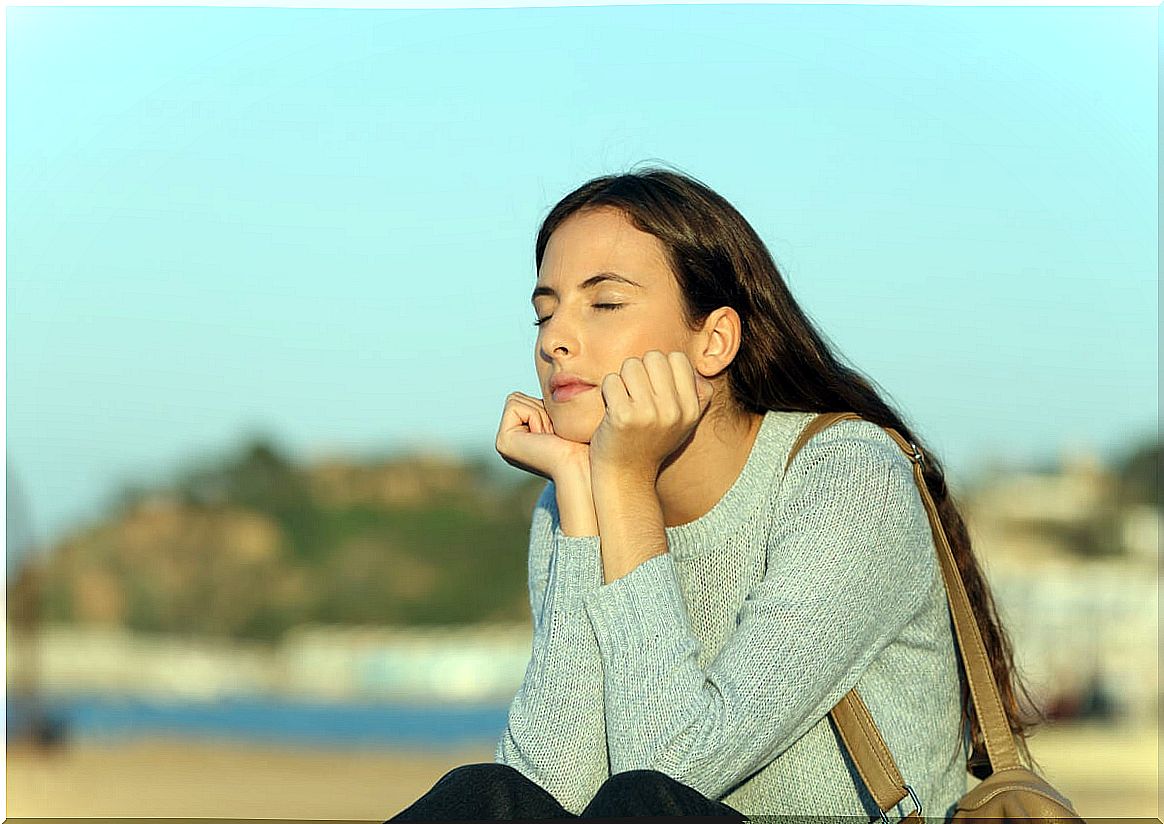 Woman with closed eyes outdoors