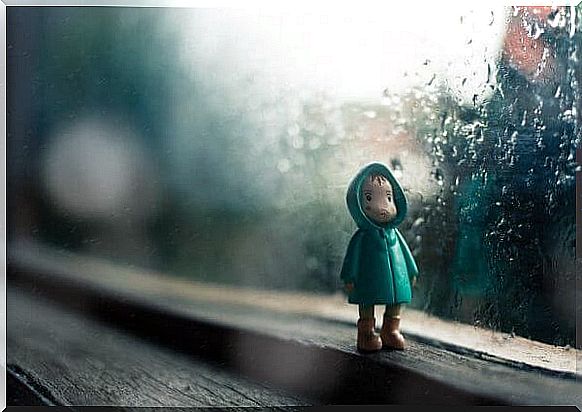 a doll of a child wearing a raincoat