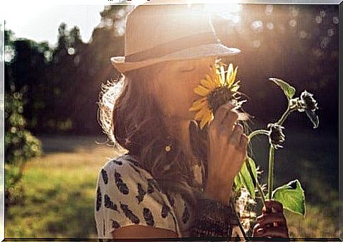 Woman smelling a flower.