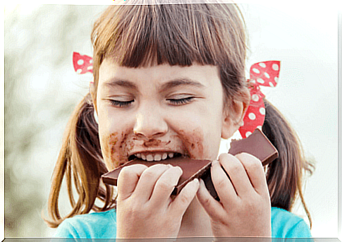 Girl eating chocolate.